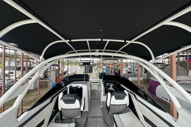 Slide: The Image of 2020 Yamaha Boats 242SE interior with sleek seating and modern design under canopy. - 17