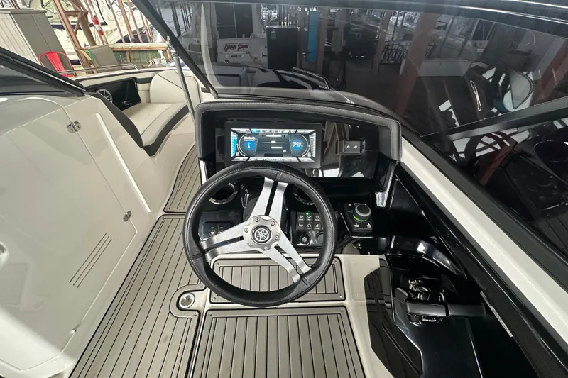 Slide: The Image of 2020 Yamaha Boats 242SE dashboard with steering wheel and digital display. - 18