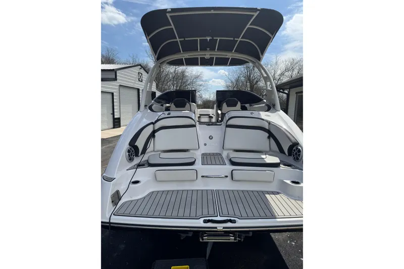 Slide: The Image of 2020 Yamaha Boats 242SE, rear view, showcasing spacious seating and sleek design. - 2