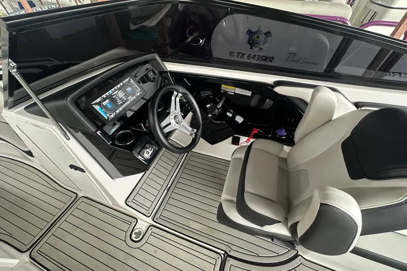 Slide: The Image of 2020 Yamaha Boats 242SE cockpit with modern steering and dashboard controls. - 23