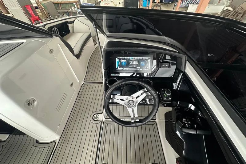Slide: The Image of 2020 Yamaha Boats 242SE interior with sleek dashboard and modern steering wheel design. - 24
