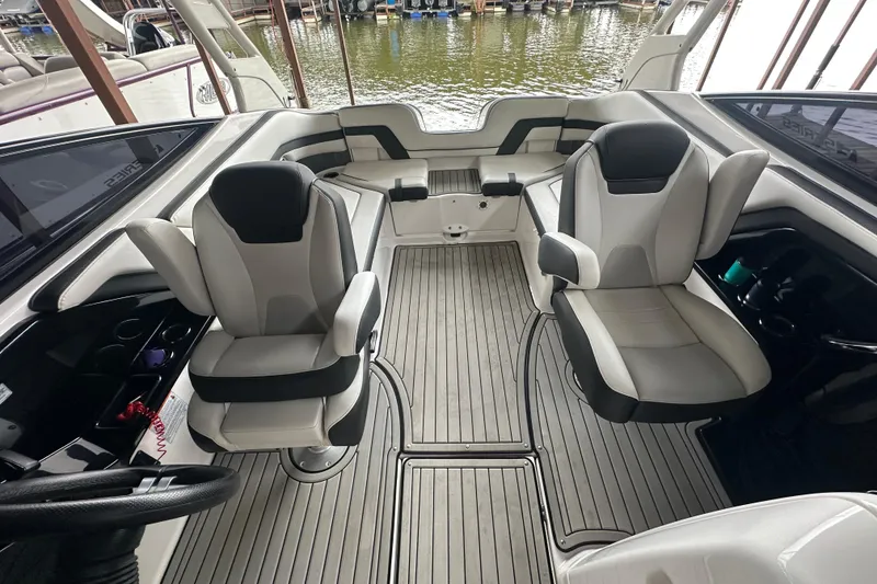 Slide: The Image of 2020 Yamaha Boats 242SE interior with dual captain's chairs and sleek design. - 26