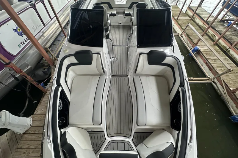 Slide: The Image of 2020 Yamaha Boats 242SE interior, featuring sleek seating and modern design in docked position. - 28