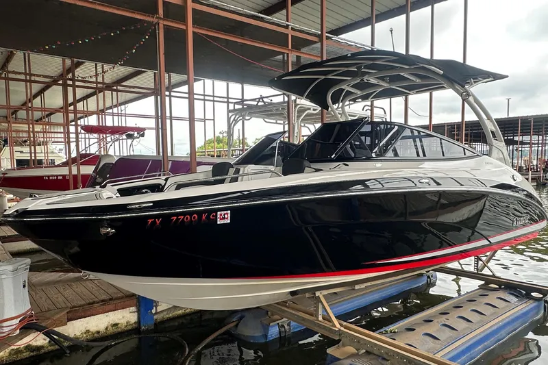 Slide: The Image of 2020 Yamaha Boats 242SE in dock, sleek black design with red accents. - 3