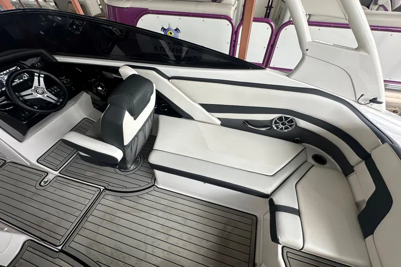 Slide: The Image of 2020 Yamaha Boats 242SE interior with sleek seating and modern dashboard design. - 31