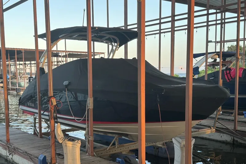 Slide: The Image of 2020 Yamaha Boats 242SE covered and docked at a marina. - 8