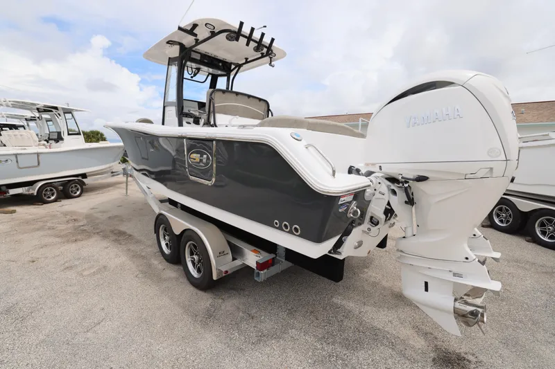 Slide: The Image of 2026 Sea Hunt Ultra 265 SE boat interior with plush seating and steering wheel. - 10