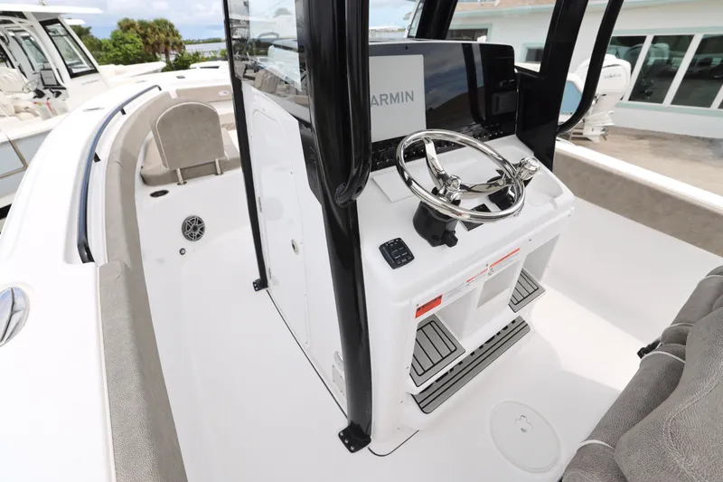 Slide: The Image of 2026 Sea Hunt Ultra 265 SE boat console with Garmin electronics and control panel. - 14