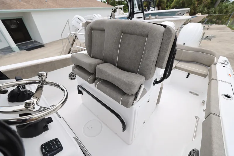 Slide: The Image of 2026 Sea Hunt Ultra 265 SE boat with cushioned seating and dual outboard motors. - 15