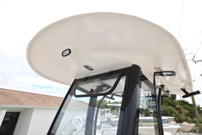 Slide: The Image of 2026 Sea Hunt Ultra 265 SE boat interior with cushioned seating and steering wheel. - 17