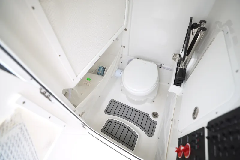 Slide: The Image of 2026 Sea Hunt Ultra 265 SE boat interior with cushioned seating and dual engines. - 6