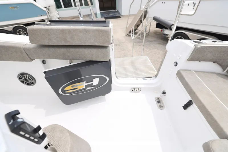 Slide: The Image of 2026 Sea Hunt Ultra 265 SE boat interior with cushioned seating and modern design. - 7