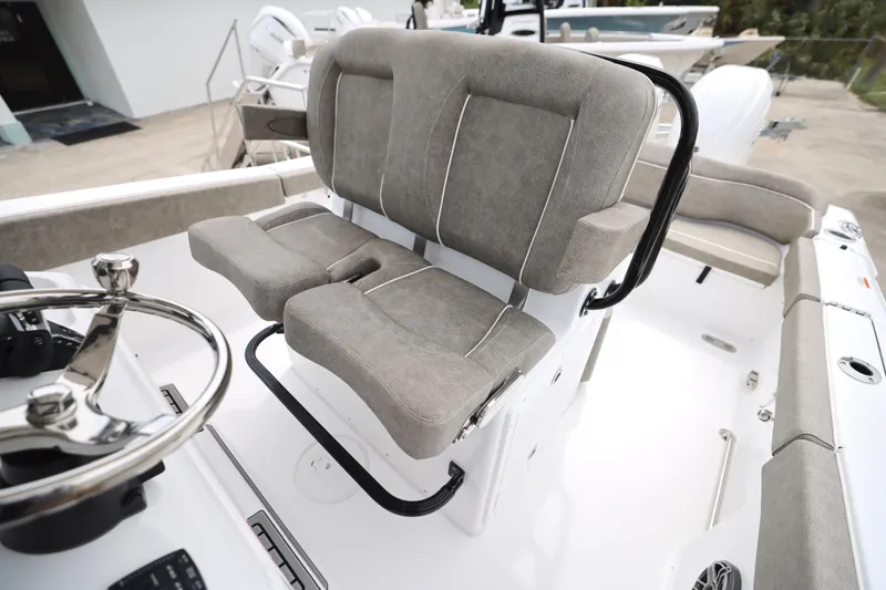 Slide: The Image of Interior of 2026 Sea Hunt Ultra 265 SE boat bathroom with toilet and storage. - 8