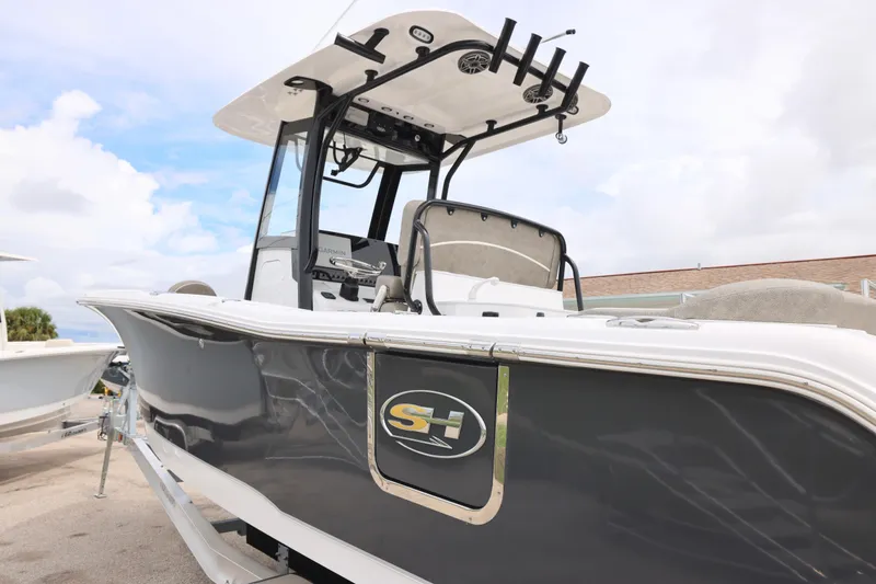Slide: The Image of 2026 Sea Hunt Ultra 265 SE boat interior with seating and logo detail. - 9