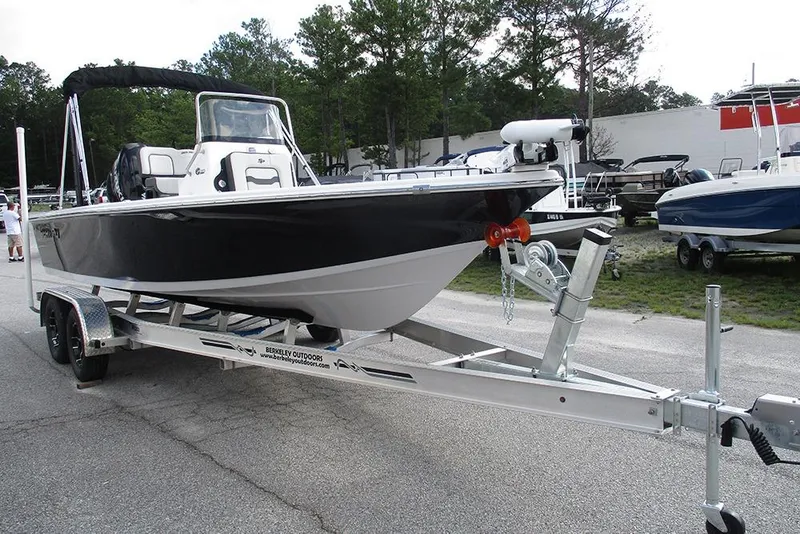 The Image of 2026 Sea Pro 210 Bay boat on trailer, parked outdoors, ready for transport. - 0