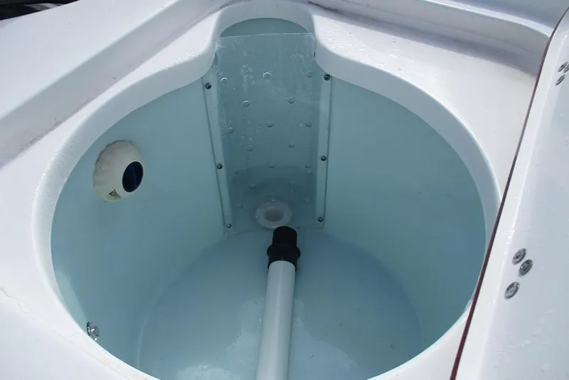 Slide: The Image of 2026 Sea Pro 210 Bay boat livewell interior, featuring a clean, white design. - 21