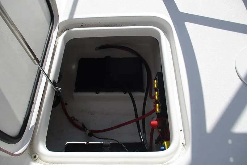 Slide: The Image of Open hatch of 2026 Sea Pro 210 Bay boat showing battery compartment. - 24