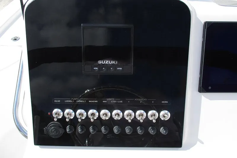 Slide: The Image of Control panel of 2026 Sea Pro 210 Bay boat with Suzuki display and switches. - 26