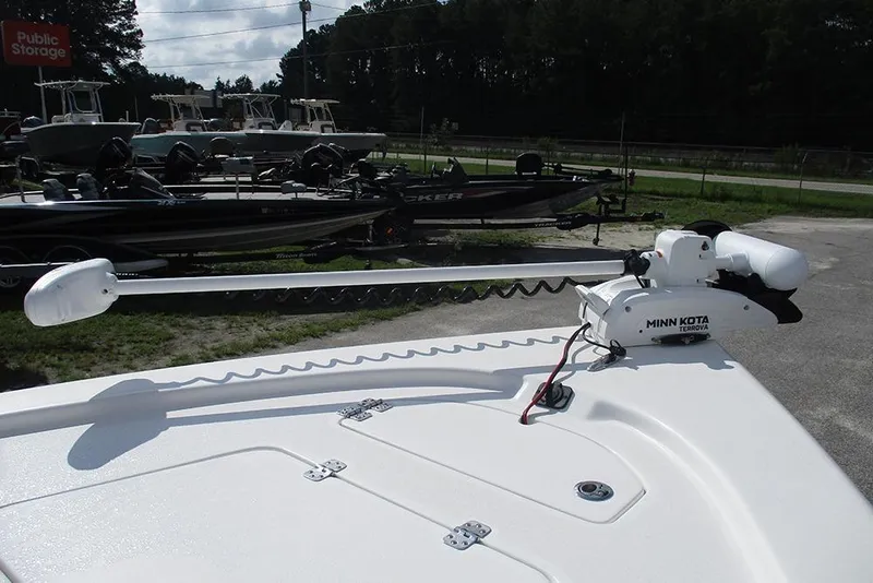 Slide: The Image of 2026 Sea Pro 210 Bay boat with Minn Kota Terrova trolling motor in a storage lot. - 27