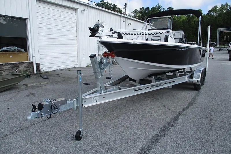 Slide: The Image of 2026 Sea Pro 210 Bay boat on trailer outside a warehouse. - 4