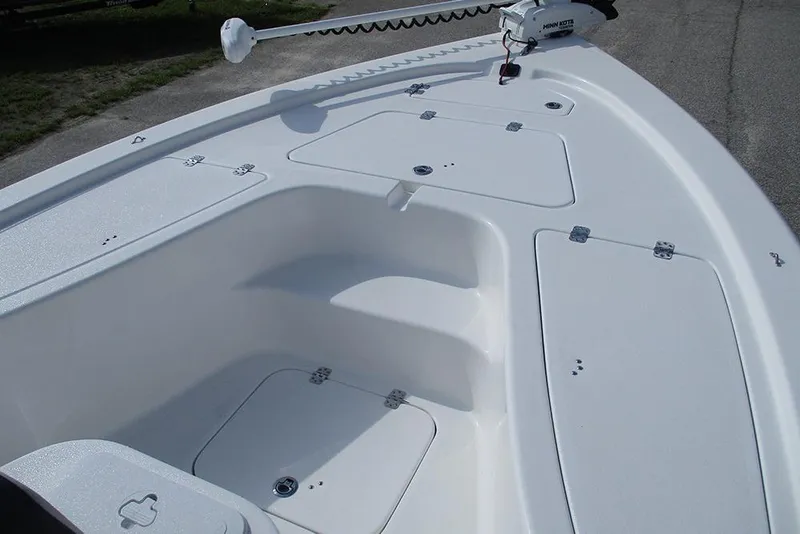 Slide: The Image of 2026 Sea Pro 210 Bay boat deck with storage compartments and trolling motor. - 9