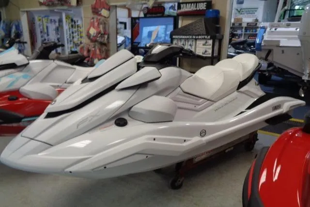 Slide: The Image of 2025 Yamaha WaveRunner FX Cruiser SVHO in showroom, sleek white design, luxury watercraft. - 2