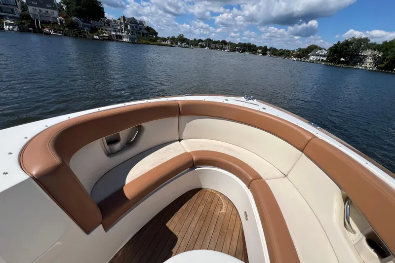 Slide: The Image of 2008 Chris-Craft Launch 28 boat with tan seating, on a scenic lake. - 16