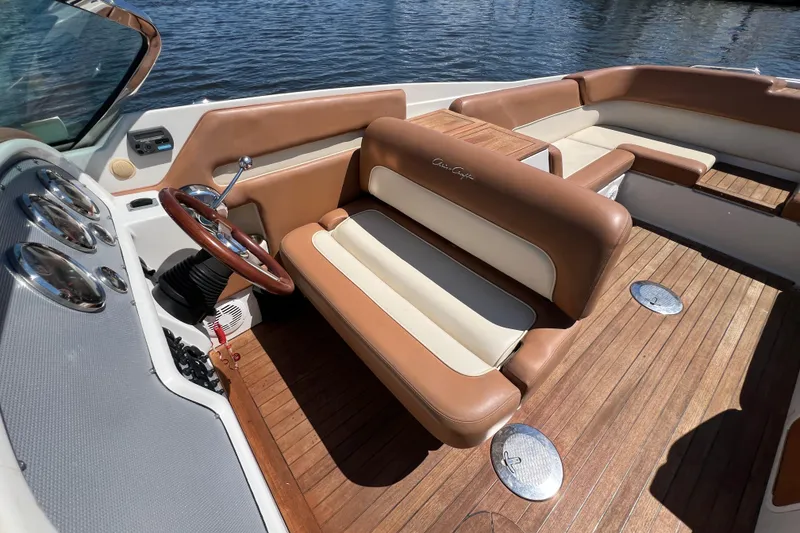 Slide: The Image of 2008 Chris-Craft Launch 28 interior with brown leather seats and wooden deck. - 20