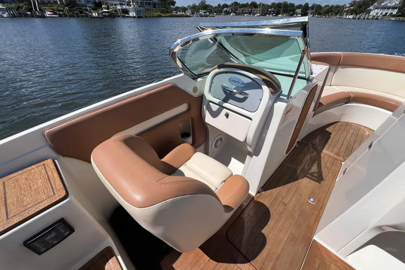 Slide: The Image of 2008 Chris-Craft Launch 28 boat interior with leather seating and wooden deck. - 22