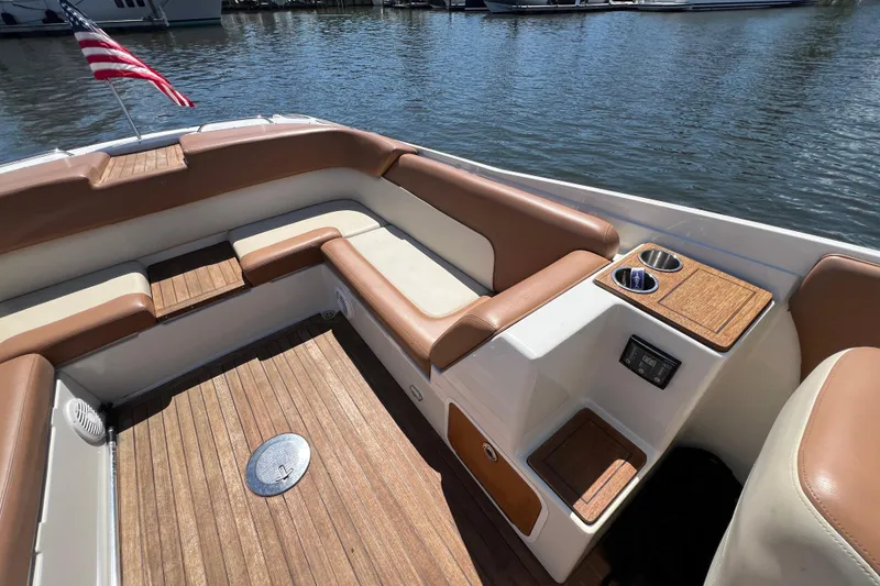 Slide: The Image of 2008 Chris-Craft Launch 28 boat interior with tan seating and wooden flooring. - 23