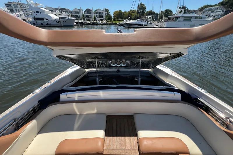 Slide: The Image of 2008 Chris-Craft Launch 28 boat interior with open engine hatch, docked at marina. - 27