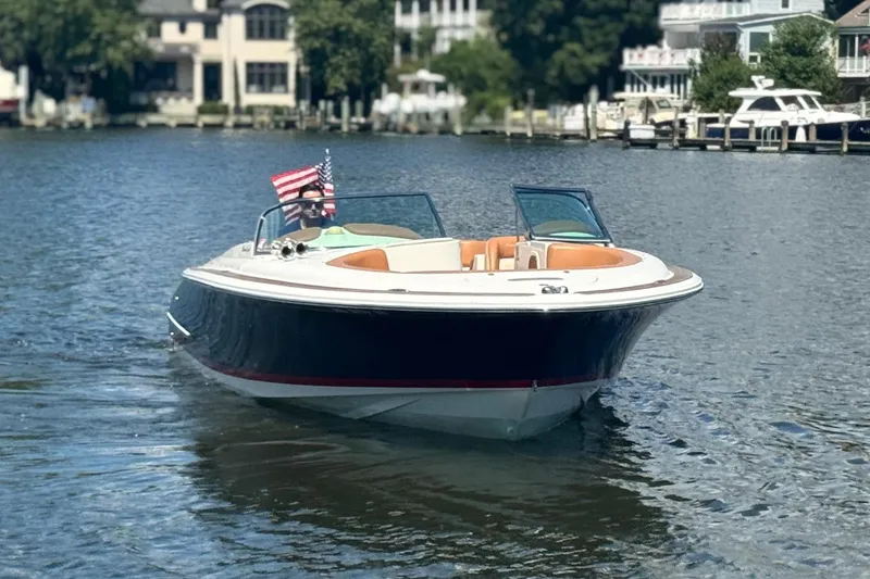 Slide: The Image of 2008 Chris-Craft Launch 28 boat on a calm lake, with American flag. - 3