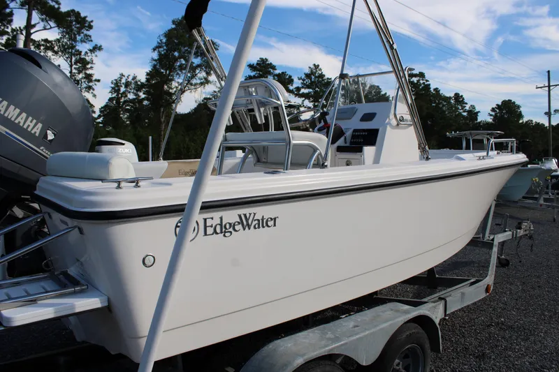Slide: The Image of 2015 Edgewater 188CC boat on trailer, featuring Yamaha engine, parked outdoors. - 10