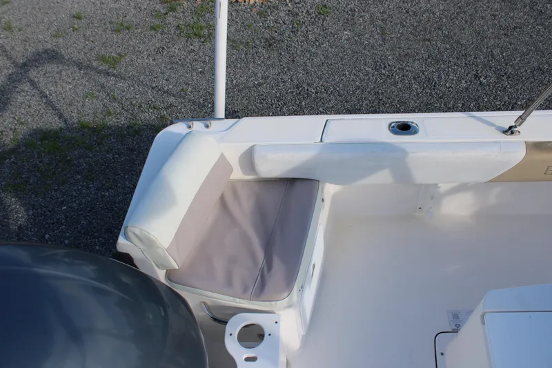 Slide: The Image of 2015 Edgewater 188CC boat interior with cushioned seating and rod holder. - 16