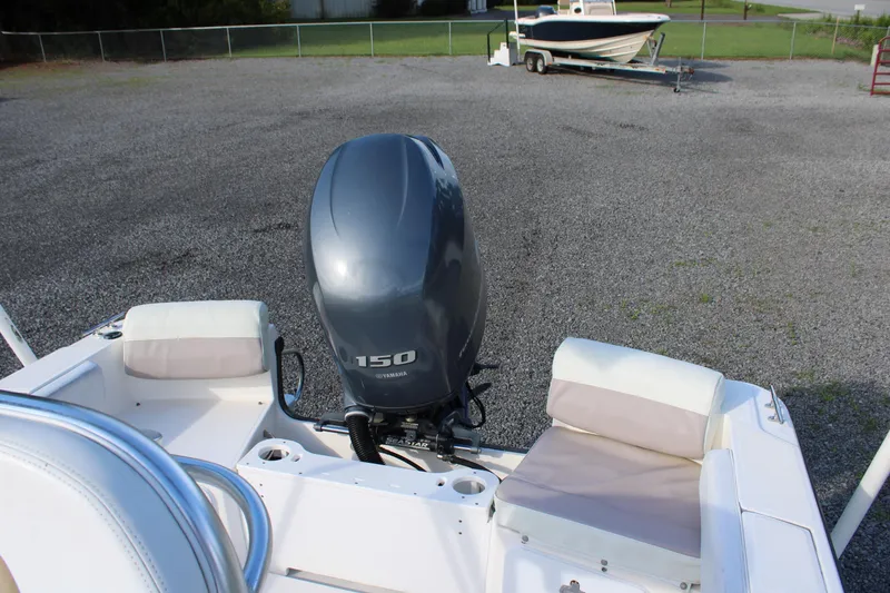 Slide: The Image of 2015 Edgewater 188CC boat with Yamaha 150 engine, parked on gravel. - 21