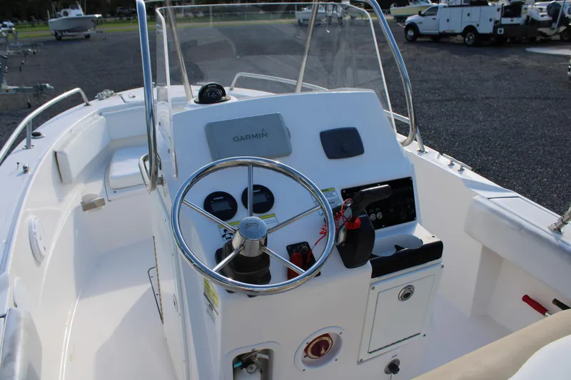Slide: The Image of 2015 Edgewater 188CC boat cockpit with steering wheel and Garmin navigation system. - 22