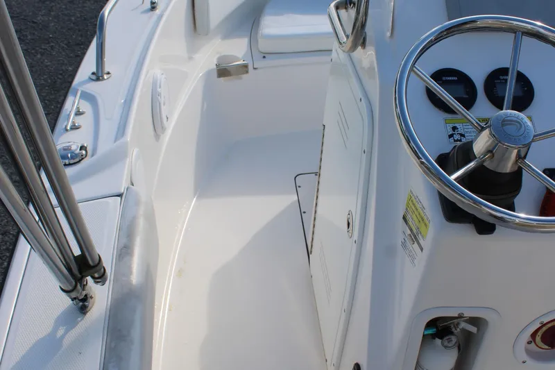 Slide: The Image of 2015 Edgewater 188CC boat cockpit with steering wheel and control panel. - 23