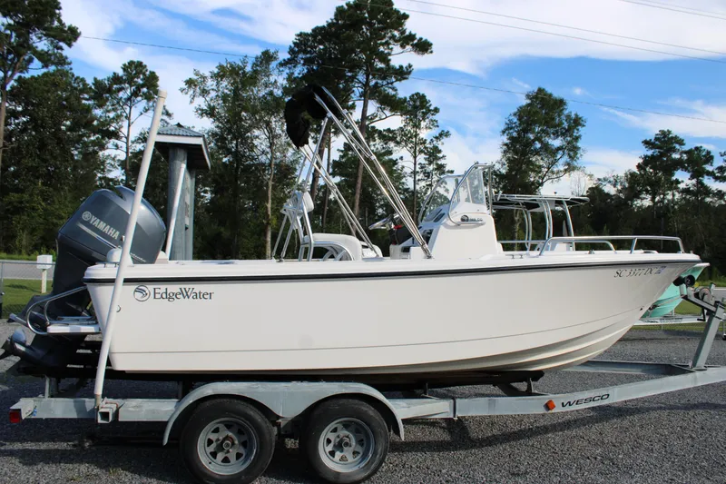 Slide: The Image of 2015 Edgewater 188CC boat on trailer with Yamaha motor, parked outdoors. - 25
