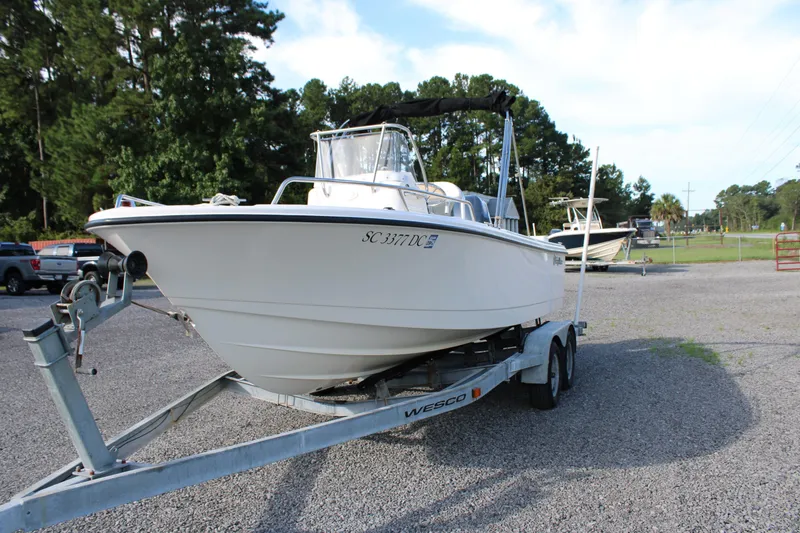 Slide: The Image of 2015 Edgewater 188CC boat on trailer in outdoor setting, surrounded by trees. - 3