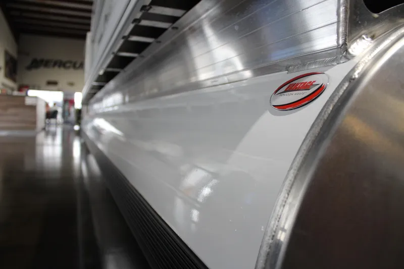 Slide: The Image of 2026 Sun Tracker Party Barge 20 DLX pontoon detail in showroom. - 11