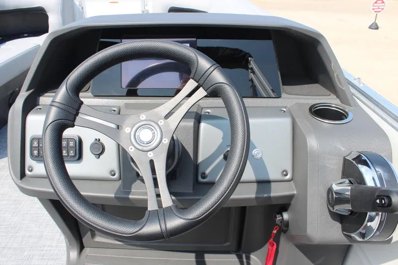Slide: The Image of Steering console of 2026 Sun Tracker Party Barge 20 DLX with modern controls. - 22