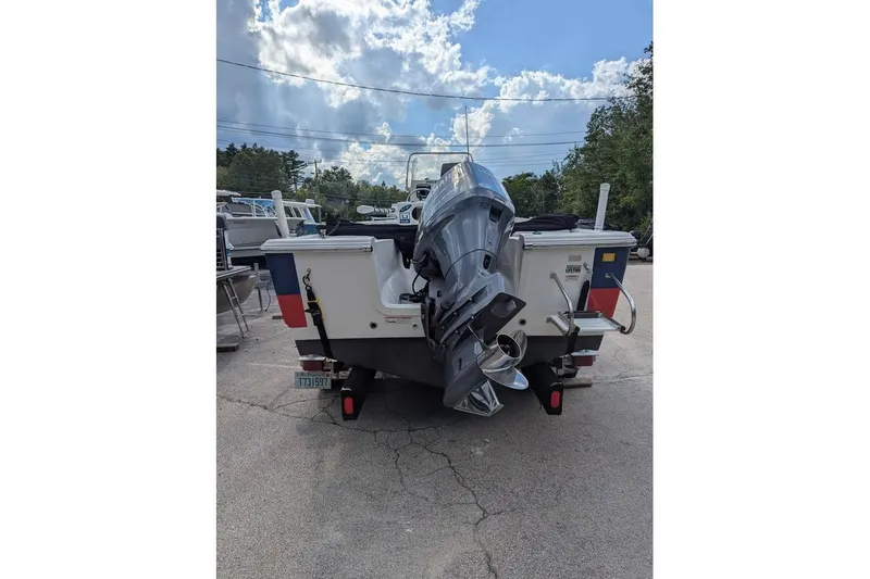 Slide: The Image of 2011 Sea Fox 206 CC PRO Series boat with outboard motor, parked outdoors. - 3