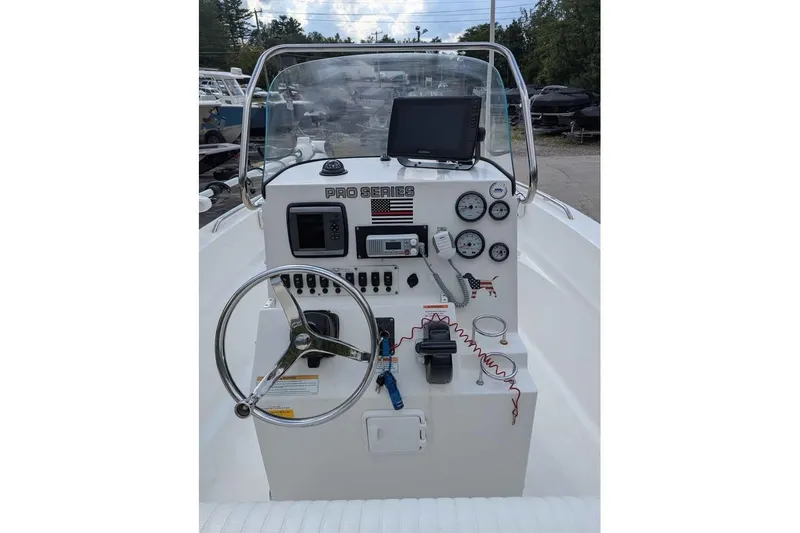 Slide: The Image of 2011 Sea Fox 206 CC PRO Series boat dashboard with steering wheel and navigation equipment. - 7