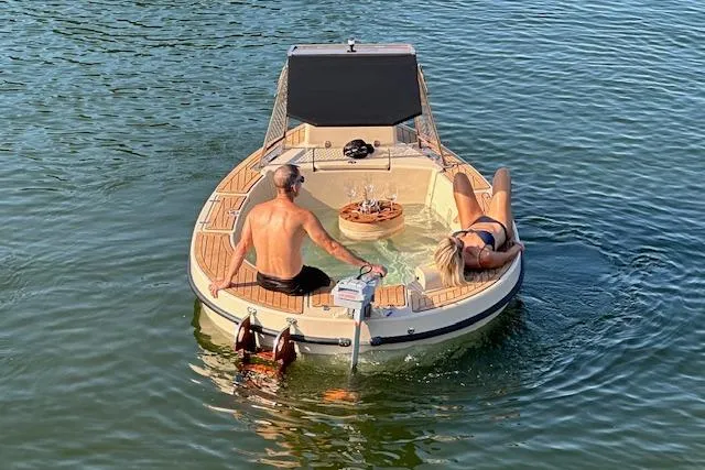 Slide: The Image of Couple relaxing on 2022 Spacruzzi V-1 boat with hot tub on a sunny day. - 4