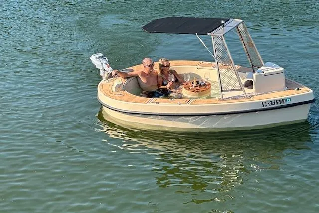 Slide: The Image of Couple enjoying a 2022 Spacruzzi V-1 boat on a sunny day. - 6