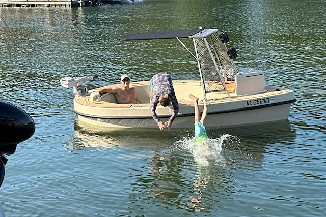 Slide: The Image of Man diving from 2022 Spacruzzi V-1 boat into lake, sunny day. - 9