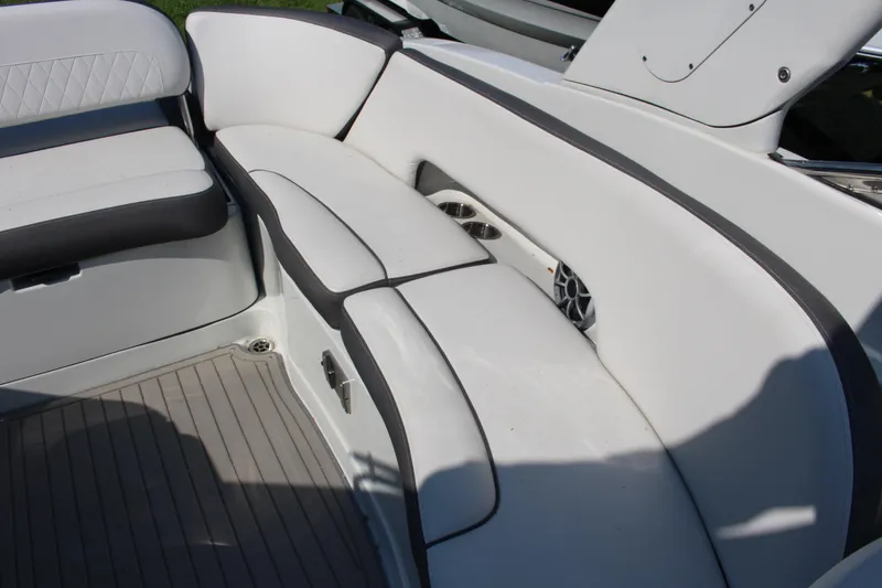 Slide: The Image of 2023 Crownline E285 boat interior with white cushioned seating and sleek design. - 12