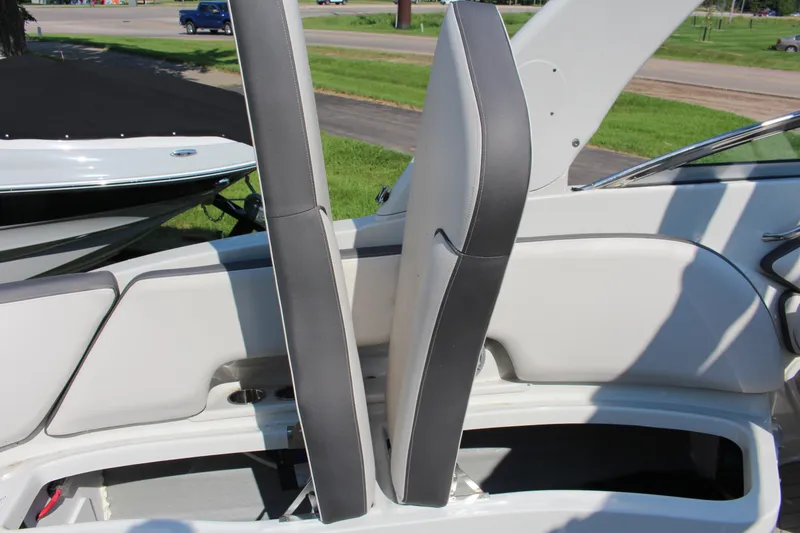 Slide: The Image of 2023 Crownline E285 boat interior seating with storage compartment open. - 14