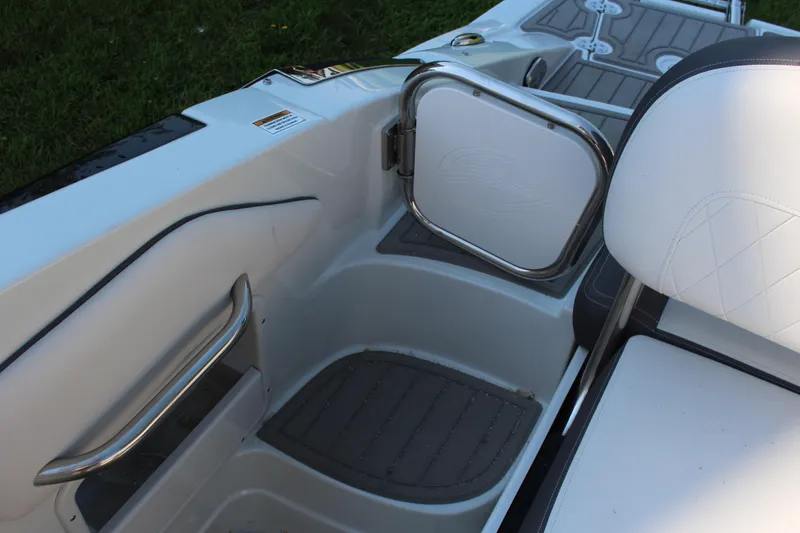 Slide: The Image of 2023 Crownline E285 boat interior with white seating and stainless steel accents. - 18
