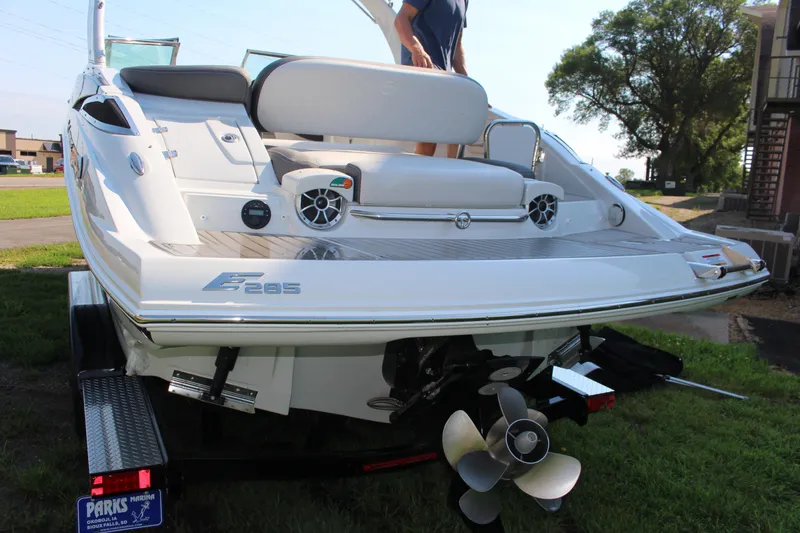 Slide: The Image of 2023 Crownline E285 boat rear view with seating and propeller on trailer. - 23